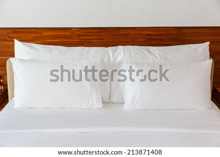white pillows on the white bed