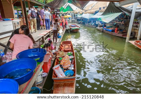 BANGKOK - AUG 2: Taling Chan Floating Market on Aug 2, 14 in Bangkok. The market sale food items, offered on rafts, and in paddle boats with the genuine atmosphere of the riverside.