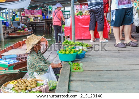 BANGKOK - AUG 2: Vendor at Taling Chan Floating Market on Aug 2, 14 in Bangkok. The market sale food items, offered on rafts, and in paddle boats with the genuine atmosphere of the riverside.