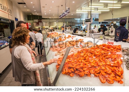SYDNEY - MAY 16: People shop at Sydney Fish Market on May 16, 2014 in Sydney. It is the world\'s 3rd largest fish market, established in 1945 by the government and was privatized in 1994.