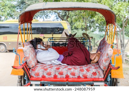 BAGAN, MYANMAR - DEC 6: Driver and the Horse cart on Dec 6, 2014 in Bagan. It is one of the popular transportation for tourist to visit pagoda in Bagan.