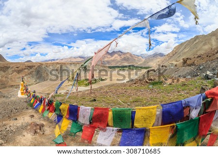 Praying flags and three stupas at Confluence of the Indus and Zanskar Rivers, leh, ladakh, india