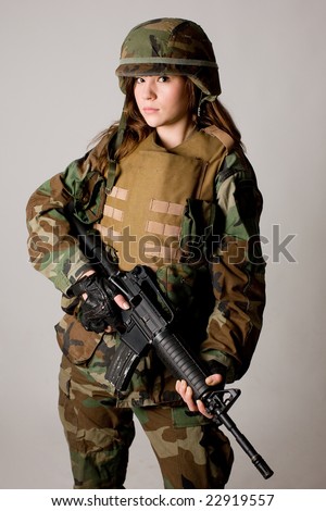 Shot of a beautiful army girl. Uniform conforms to special services(soldiers) of the NATO countries. Shot in studio. Isolated on white.