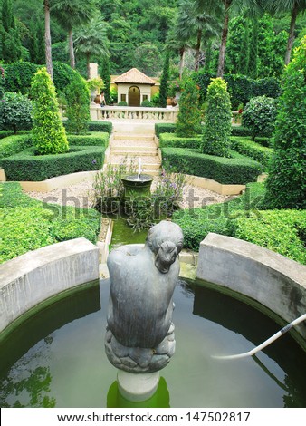 old fountain with lonely woman sculpture in the garden