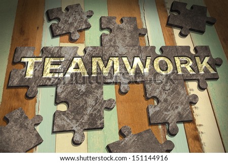 teamwork concept with  jigsaw puzzle on wooden table background,business concept