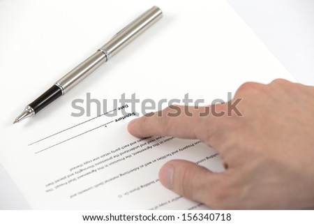Signing a contract - hand with pen closeup