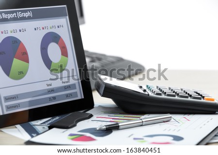 workplace with paper and electronic documents on table
