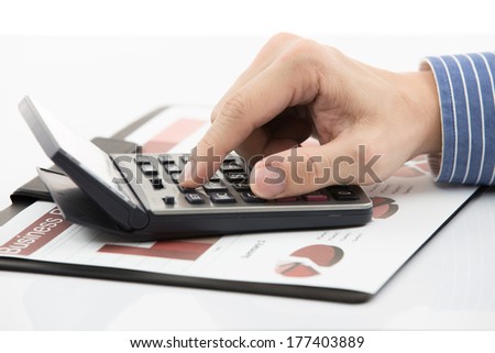 Male hand with pen analyzing financial data. Accounting