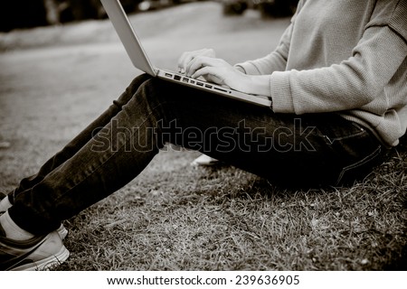 Young Caucasian woman using Laptop on nature