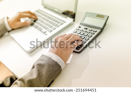 Closeup of businessman hands typing on laptop computer