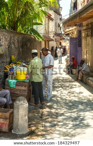 STONE TOWN, ZANZIBAR/TANZANIA - APRIL 4 2012: Local people on the streets in heart of city, which mostly consists of a maze of narrow alleys lined by houses, shops, bazaars and mosques.