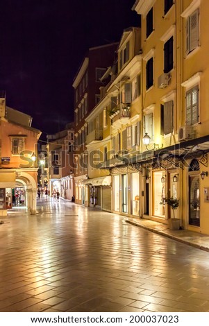 KERKYRA, CORFU, GREECE - SEPTEMPER 19 2013: Tourists walking and shopping on narrow streets in the historical Kerkyra city center in Corfu at night