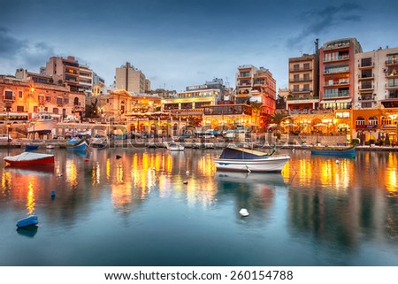 MALTA - JANUARY 19 2015: Spinola Bay with boats in front of famous touristic restaurants at St Julian, Malta
