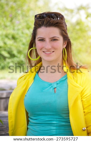 Stylish girl in bright clothes smiles