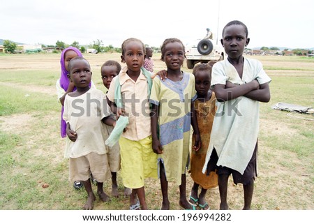 MUKJAR ,Southern Sudan - September 16, 2011 : Unidentified young African boys and girl pose and look at camera.People of Benin suffer of poverty due to the difficult economic situation.