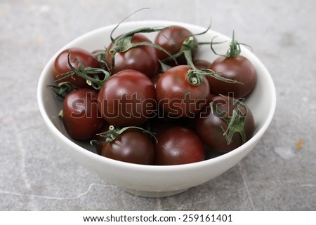 black tomatoes in bowl