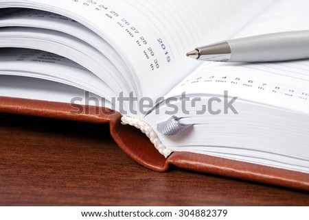 Open notebook and pen for writing
