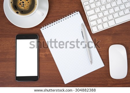 Office table with notebook, computer keyboard and mouse, tablet pc and smartphone