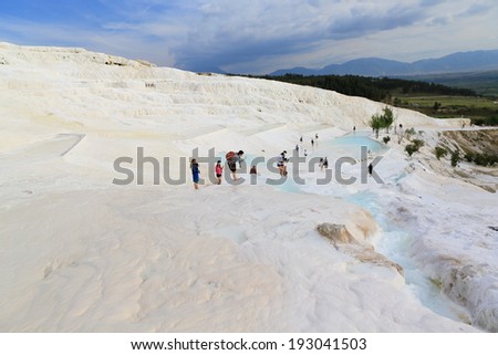 PAMUKKALE, TURKEY - APRIL, 16: Tourists on Pamukkale travertines on April 16, 2014 in Pamukkale, Turkey. Pamukkale, UNESCO world heritage site, nowadays become one of the most visited sight in Turkey.