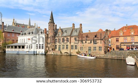 Bruges, Belgium, April 16, 2015. Tourists on a canal boat tour