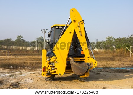 JCB machinery  parking in field, Utility machine used for soil work.