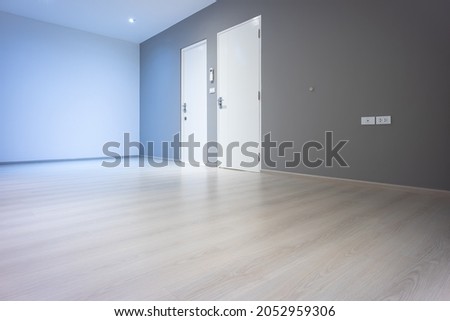 Closed wooden door inside empty room at perspective view. Entrance of room inside house building. Include wooden floor or laminate, white gray wall. New clean surface of wooden texture look modern. Photo stock © 