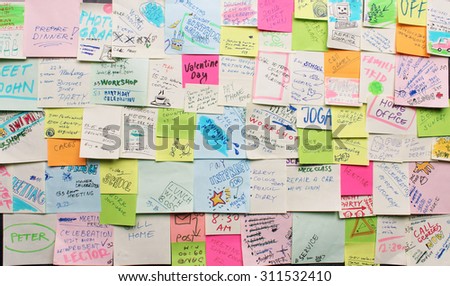 Post-it notes arranged on the wall - busy concept
