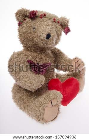 Valentine\'s Day Teddy bear with flowers and a red heart isolated on white background