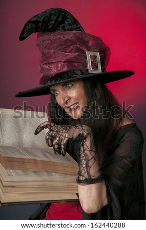 Halloween witch casting spells on red background