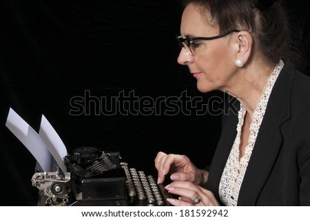 Vintage 1940's style woman in office situation, struggling with her typewriter, isolated on black background