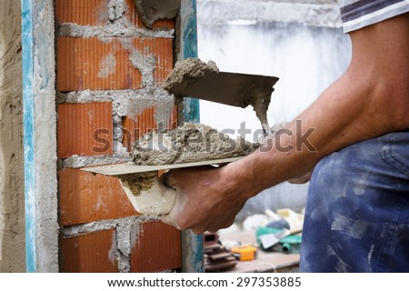 Construction workers working on site. Works at home. Reform facade. Worker wearing the facade of a house.