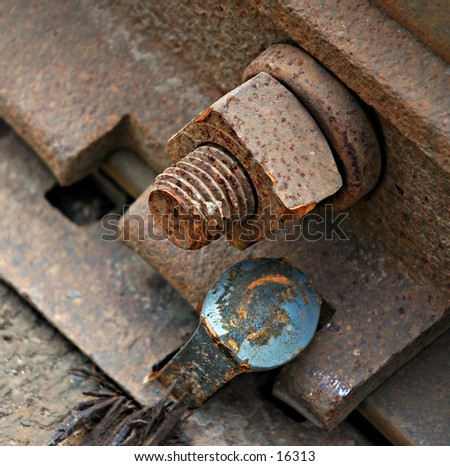 Rusted bolt and screw with nail of train tracks