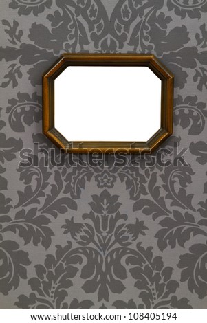 Blank vintage wooden picture frame on ornamental wallpaper