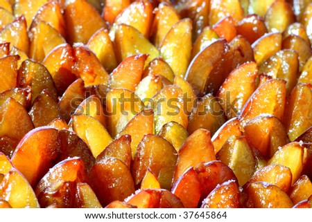 Fresh plums on a plum cake on bright background