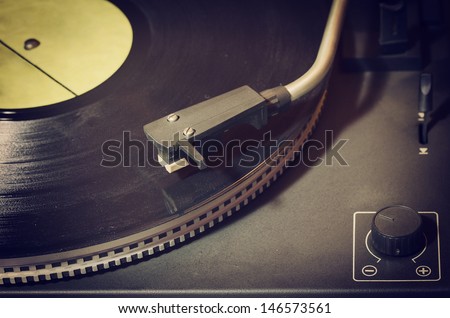 Old record player with vinyl disk
