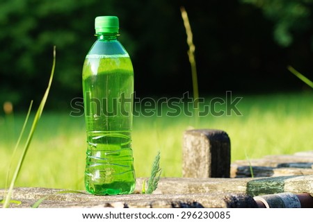 Drink in a green  plastic bottle on a hot day