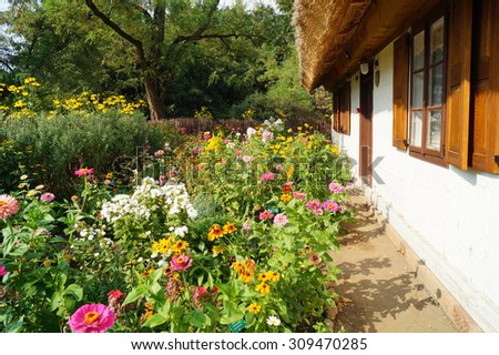 Garden at home - Farm, white wooden buildings of the area of the museum - reconstruction of XX century - Lodz, Poland