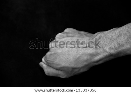 White fist on black background