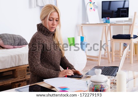 Domestic economy. Woman checking bills at home