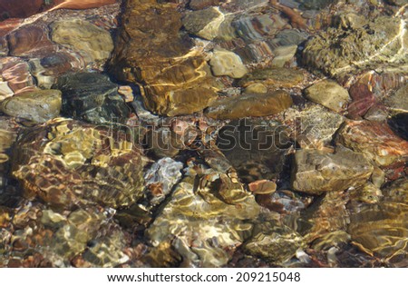 Clear sea water and stones on the floor, low-tide time