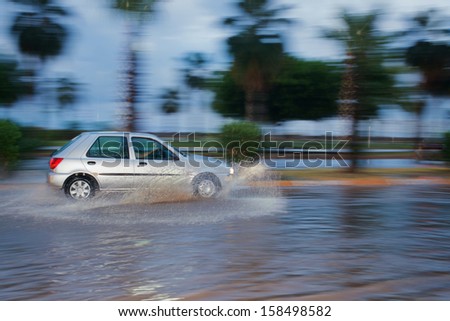 splash by a car as it goes through flood water