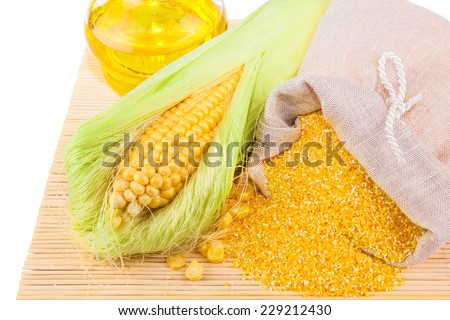 Composition from corn, maize flour and corn oil on the mat isolated on white background