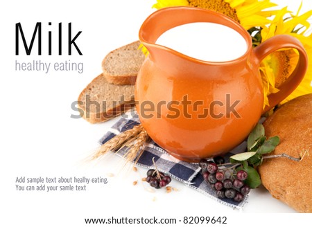 jug with milk and bread isolated on white background