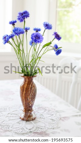 Spring bunch blue flower in vase on table