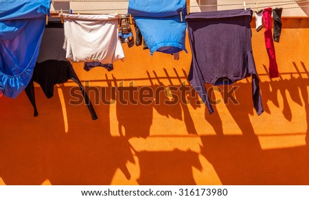 Clothes on rope dry after wash with shadow