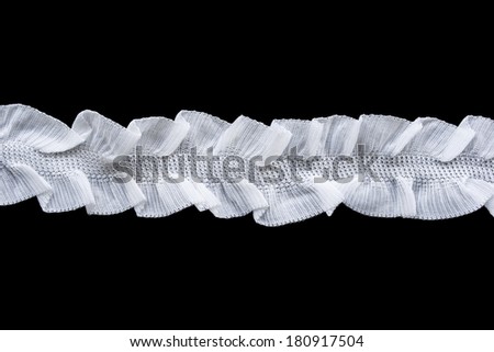 Strip of white lace on black background
