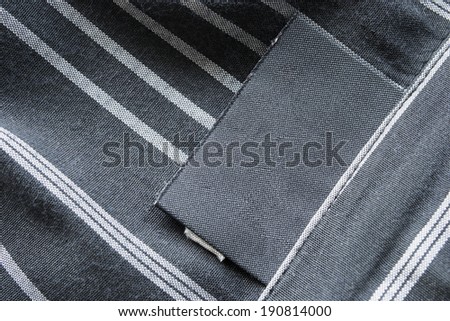 Blank black label on black striped cloth
