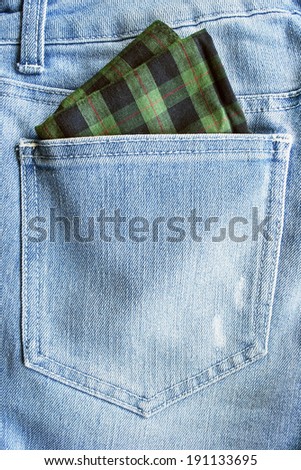 Green handkerchief in a jeans hip pocket closeup