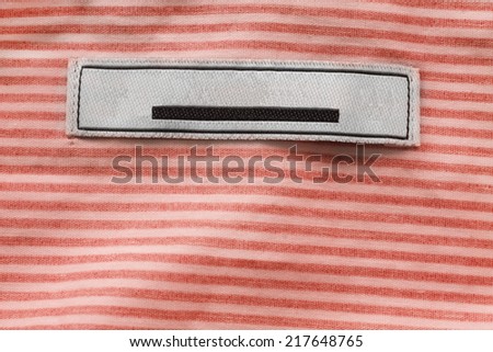 Blank label on striped orange cloth as a background