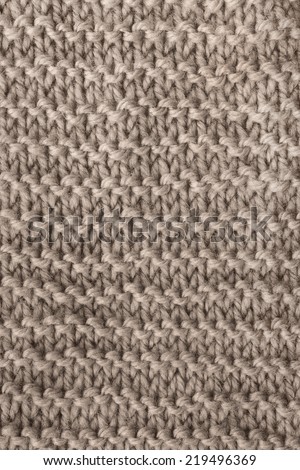 Texture of beige knitted cloth as a background